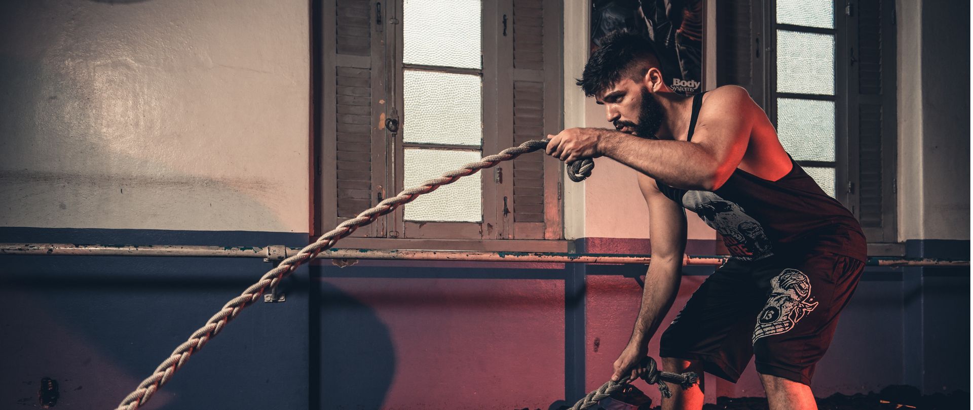 man using gym ropes