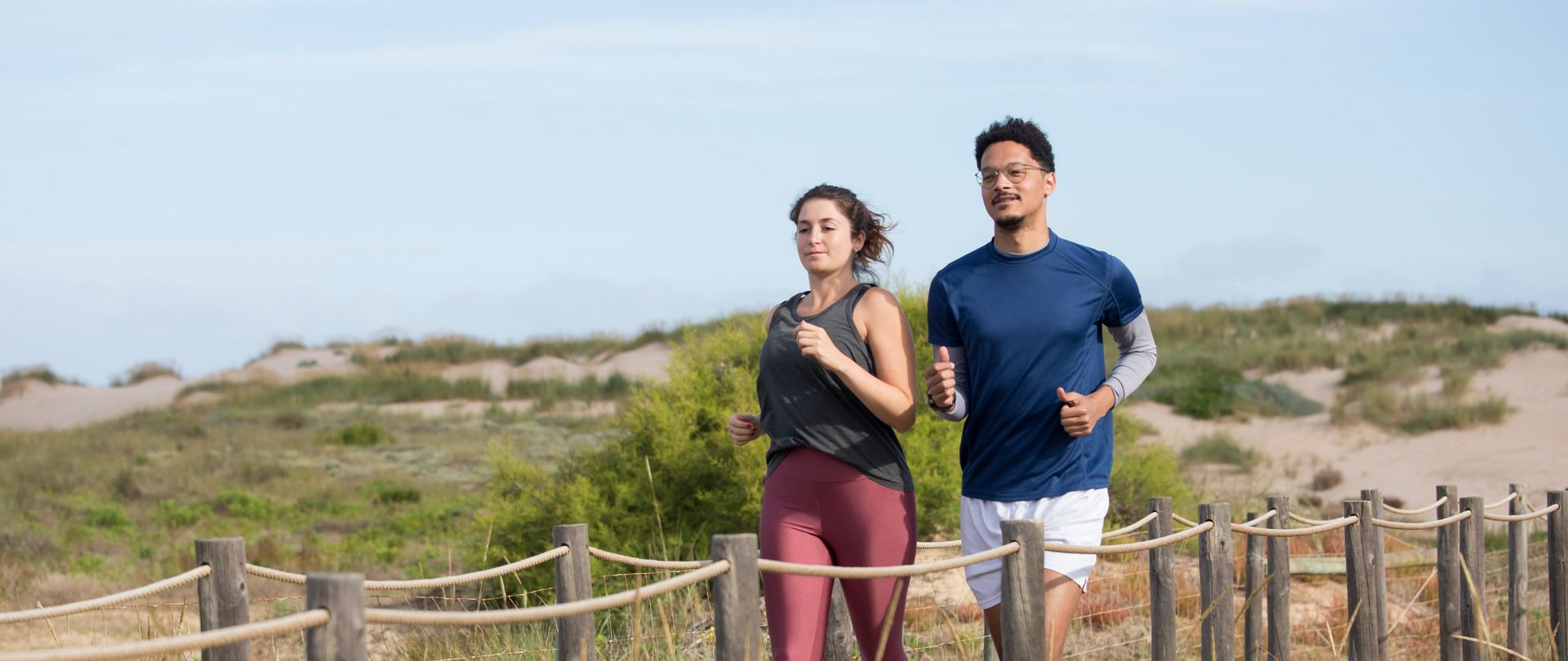 man and woman jogging outside