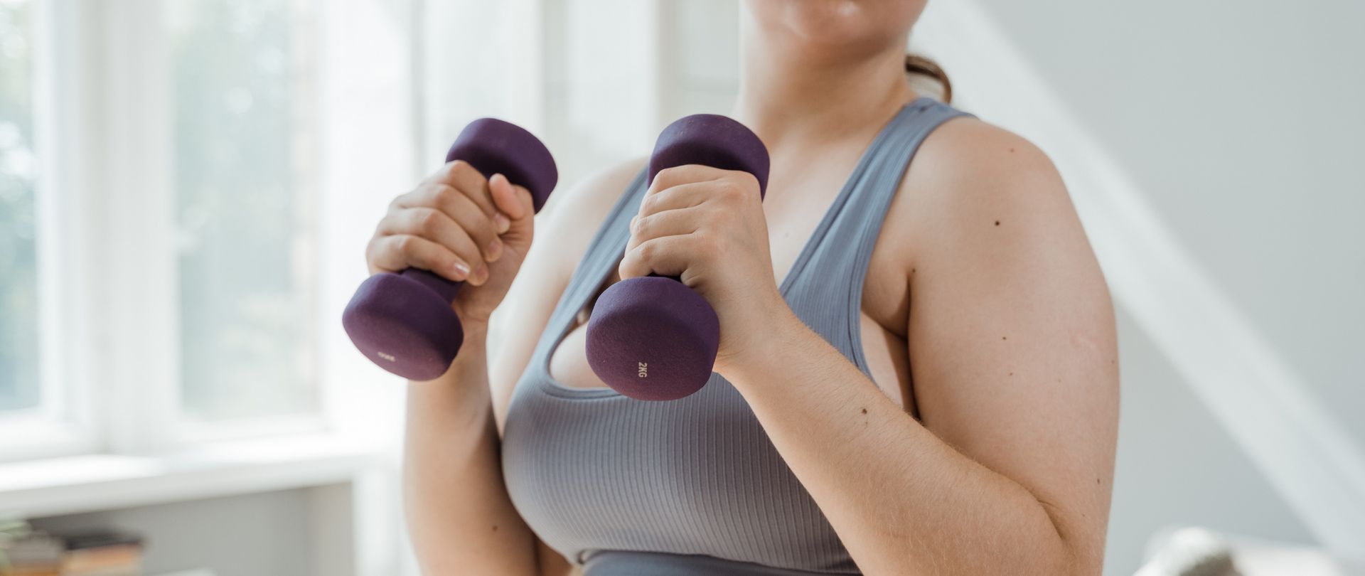 woman with purple dumbbells