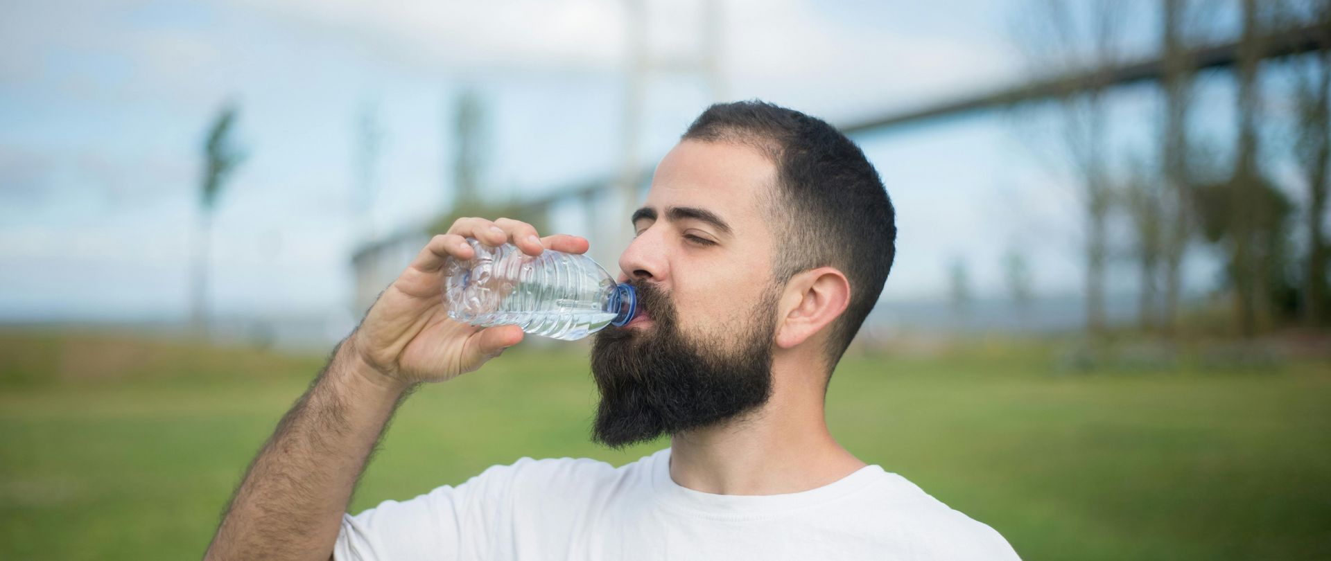 man drinking water bottle